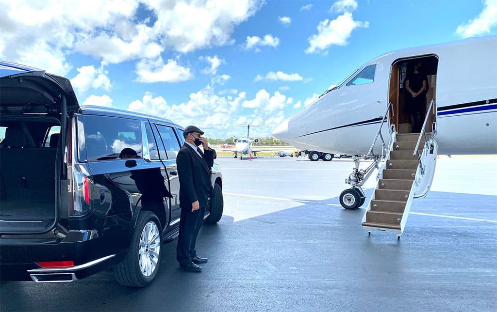 Chauffeured SUV meeting a private jet